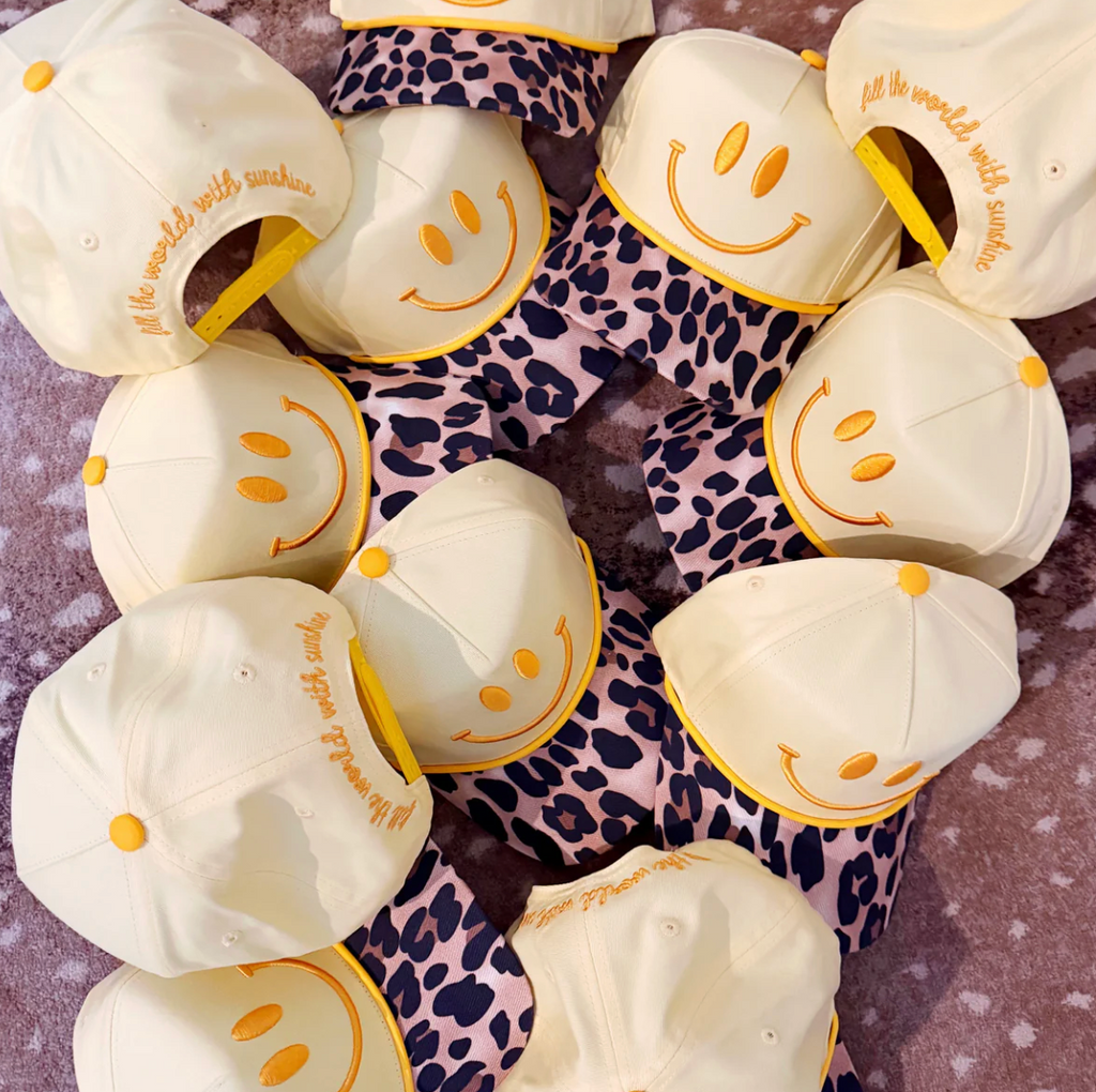 White hats with smiley faces and text on a patterned background